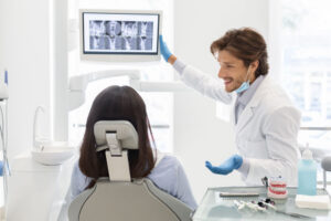 Dentist discussing digital x-rays with patient.
