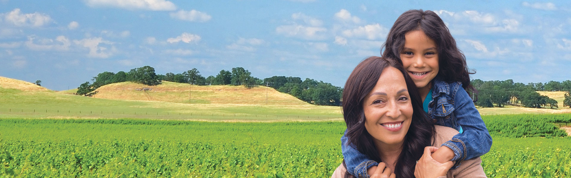 mother and daughter in rolling hills field